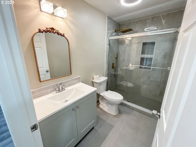 bathroom with toilet, a stall shower, vanity, and tile patterned flooring