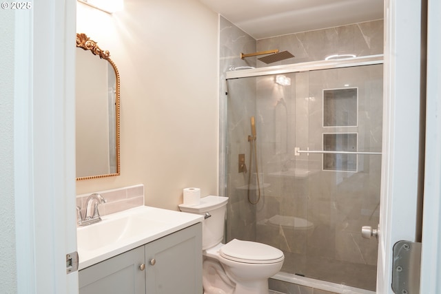 full bath featuring a stall shower, toilet, and vanity