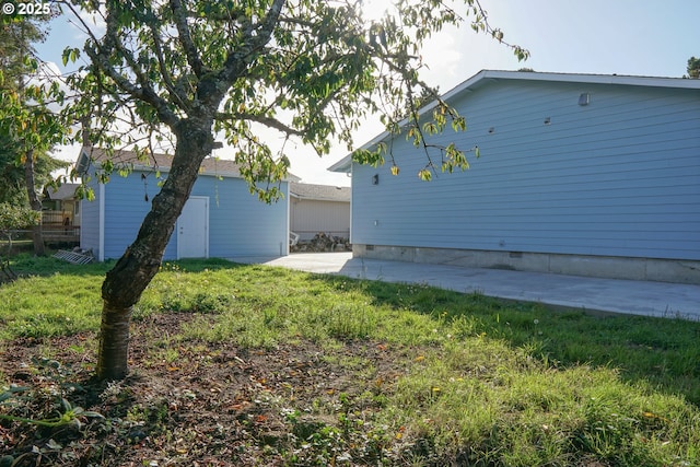 exterior space featuring crawl space, a patio area, a lawn, and fence