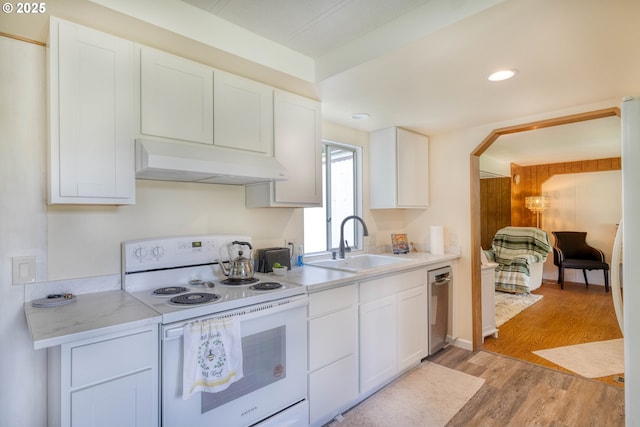 kitchen with electric stove, under cabinet range hood, a sink, stainless steel dishwasher, and light wood finished floors