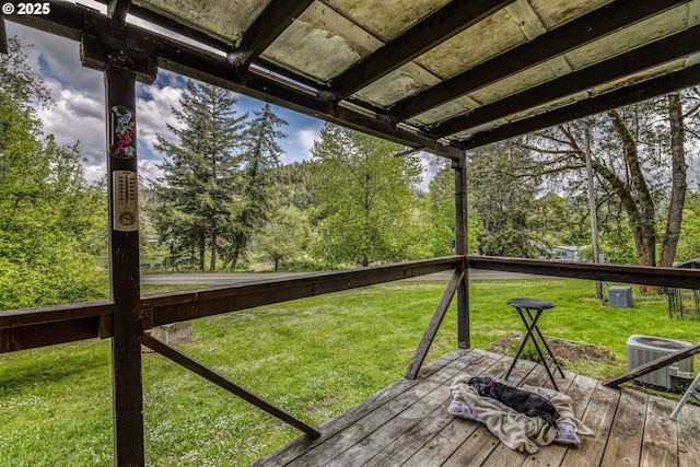 wooden deck with central AC and a lawn