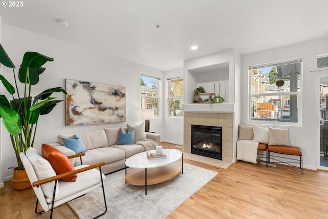 living room with a healthy amount of sunlight, light hardwood / wood-style floors, and a fireplace