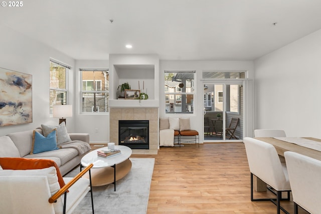 living room featuring hardwood / wood-style floors and a tiled fireplace