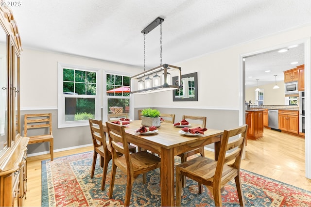 37330 SE Dodge Park Blvd, Boring, OR 97009 - dining room with a textured ceiling, light wood-style flooring, baseboards, and crown molding