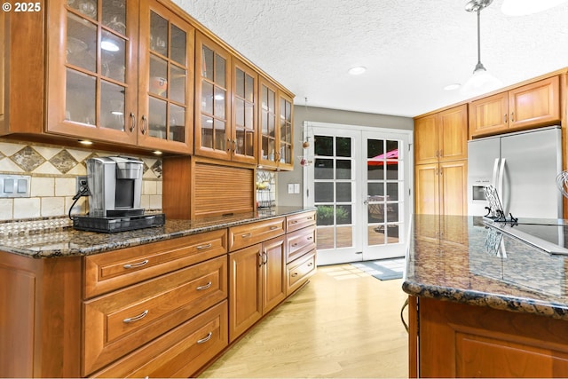 37330 SE Dodge Park Blvd, Boring, OR 97009 - kitchen with fridge with ice dispenser, french doors, tasteful backsplash, glass insert cabinets, and recessed lighting