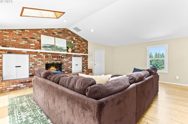 37330 SE Dodge Park Blvd, Boring, OR 97009 - living area with vaulted ceiling, light wood-style flooring, a brick fireplace, baseboards, and a skylight