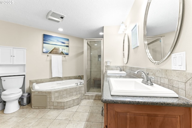 37330 SE Dodge Park Blvd, Boring, OR 97009 - bathroom with double vanity, a shower stall, a garden tub, toilet, and a textured ceiling
