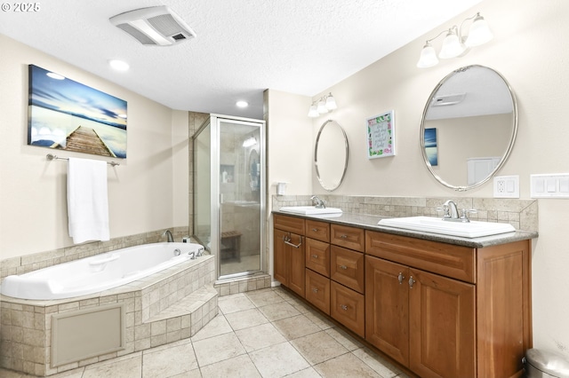 37330 SE Dodge Park Blvd, Boring, OR 97009 - bathroom with double vanity, a stall shower, a garden tub, a textured ceiling, and tile patterned floors
