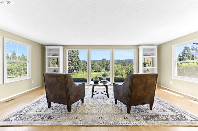 37330 SE Dodge Park Blvd, Boring, OR 97009 - living area featuring wood finished floors, healthy amount of natural light, baseboards, and a textured ceiling