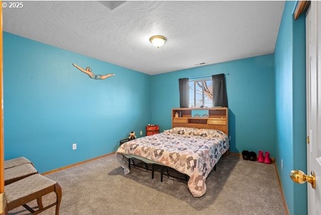 bedroom featuring a textured ceiling and carpet