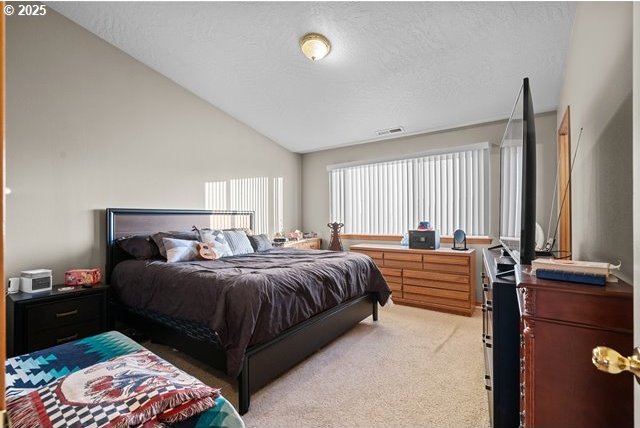 carpeted bedroom featuring vaulted ceiling