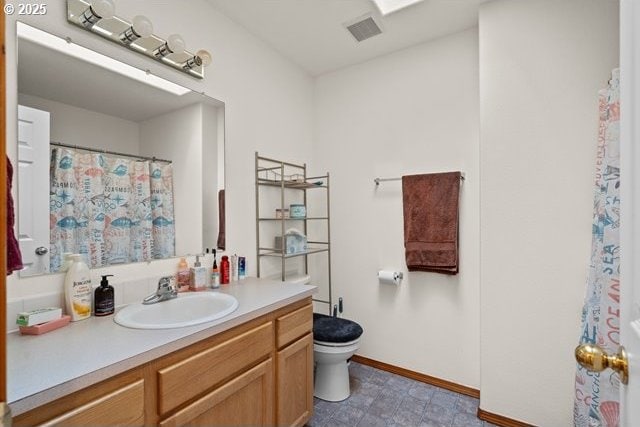 bathroom featuring toilet and vanity