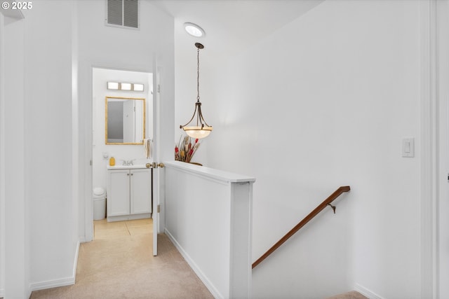 288 NE Hyde Cir, Hillsboro, OR 97124 - corridor featuring an upstairs landing, light colored carpet, baseboards, and a sink
