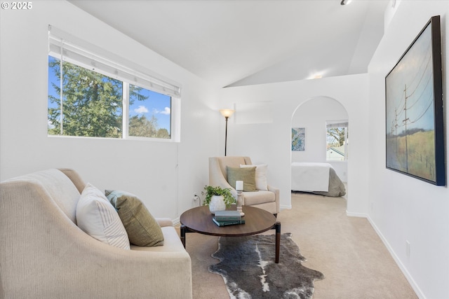 288 NE Hyde Cir, Hillsboro, OR 97124 - living room with carpet floors, vaulted ceiling, arched walkways, and baseboards