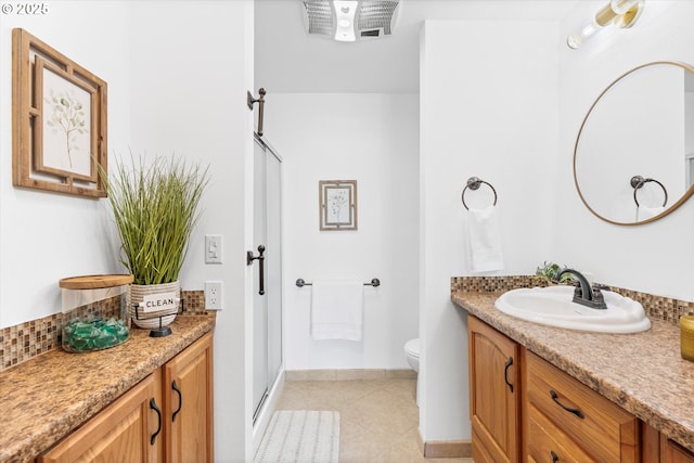 288 NE Hyde Cir, Hillsboro, OR 97124 - bathroom with vanity, toilet, tile patterned flooring, baseboards, and a shower with door