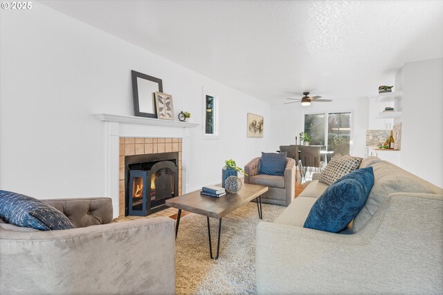 288 NE Hyde Cir, Hillsboro, OR 97124 - living area with a tiled fireplace and ceiling fan