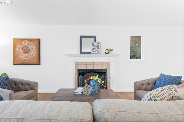 288 NE Hyde Cir, Hillsboro, OR 97124 - living area with a tiled fireplace, baseboards, and wood finished floors