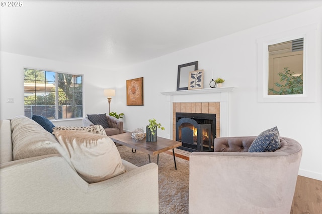 288 NE Hyde Cir, Hillsboro, OR 97124 - living room featuring a tiled fireplace, wood finished floors, and baseboards