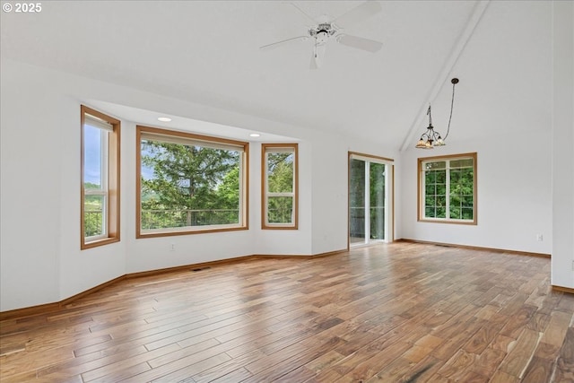 empty room with wood finished floors, a ceiling fan, baseboards, high vaulted ceiling, and recessed lighting