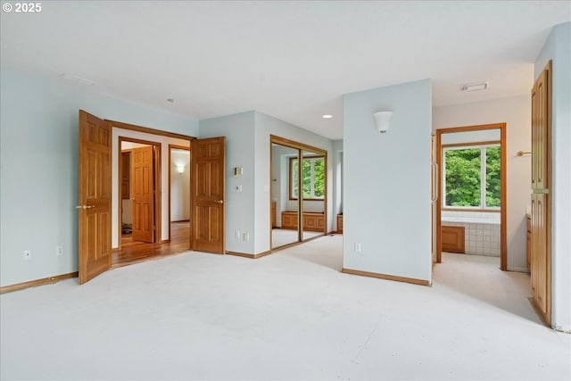 spare room with baseboards, light colored carpet, and recessed lighting