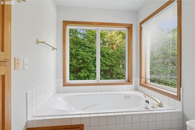 bathroom featuring plenty of natural light and a garden tub