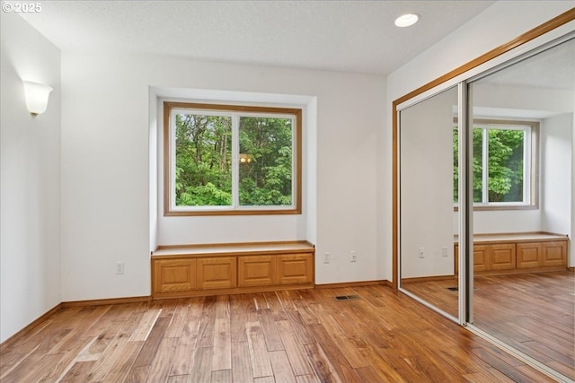 interior space featuring light wood-style floors and baseboards