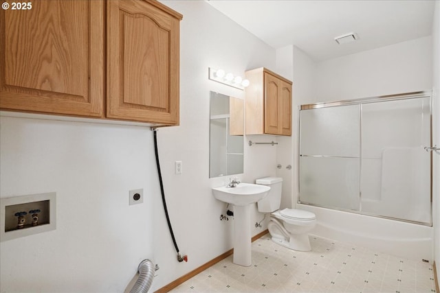 full bath with toilet, baseboards, shower / bath combination with glass door, and a sink
