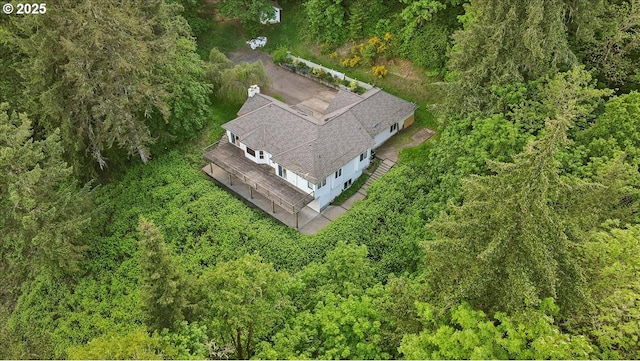 view of subject property featuring a heavily wooded area