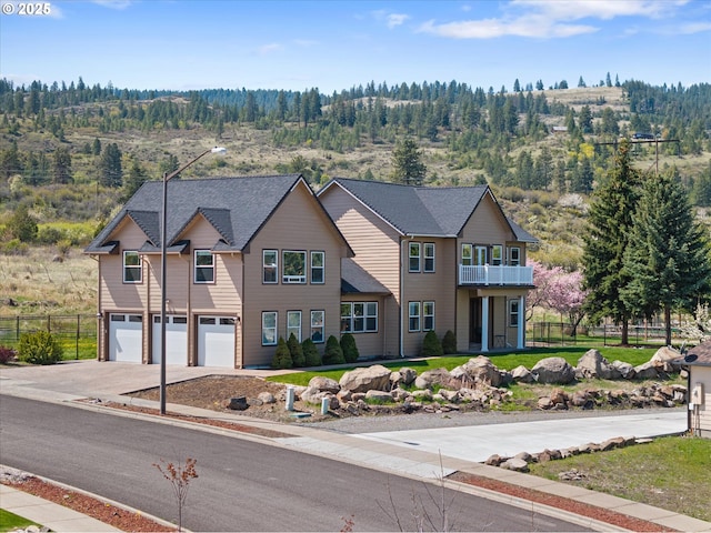 130 Ridge Dr, La Grande, OR 97850 - traditional home with a garage, fence, driveway, and a wooded view