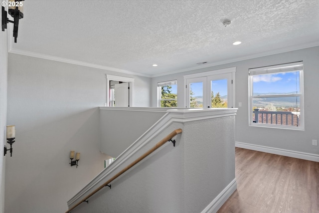 130 Ridge Dr, La Grande, OR 97850 - stairs with crown molding, a textured ceiling, baseboards, and wood finished floors