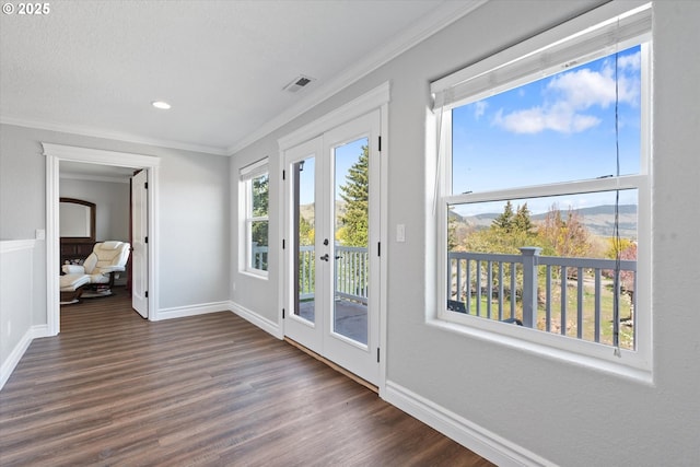 130 Ridge Dr, La Grande, OR 97850 - doorway to outside featuring visible vents, ornamental molding, and dark wood-type flooring