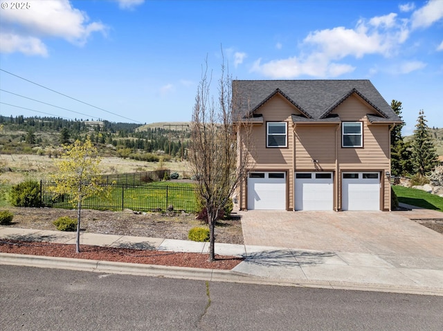 130 Ridge Dr, La Grande, OR 97850 - chalet / cabin featuring a garage, fence, and concrete driveway