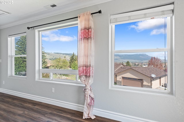 130 Ridge Dr, La Grande, OR 97850 - room details with crown molding, baseboards, a mountain view, and wood finished floors
