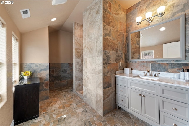 130 Ridge Dr, La Grande, OR 97850 - bathroom with visible vents, recessed lighting, vanity, and tile walls