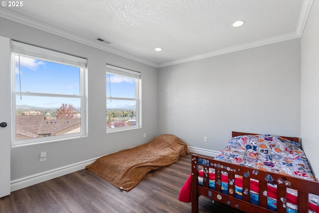 130 Ridge Dr, La Grande, OR 97850 - bedroom featuring crown molding, baseboards, wood finished floors, and visible vents