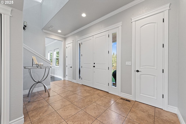 130 Ridge Dr, La Grande, OR 97850 - foyer featuring crown molding, baseboards, light tile patterned floors, and visible vents
