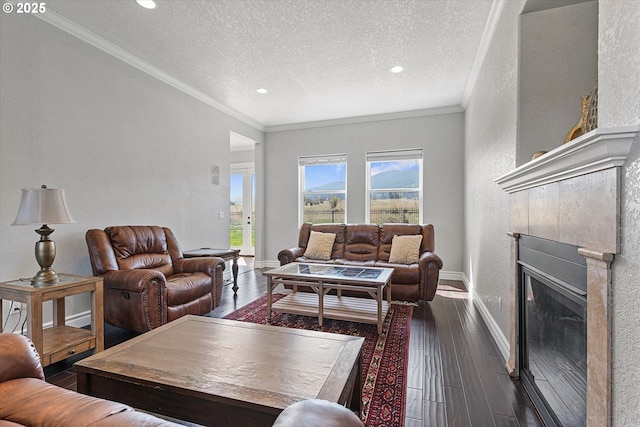 130 Ridge Dr, La Grande, OR 97850 - living room featuring a textured ceiling, a glass covered fireplace, baseboards, dark wood-type flooring, and ornamental molding