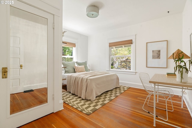 bedroom with wood finished floors and baseboards