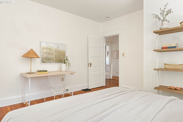 bedroom featuring wood finished floors and baseboards