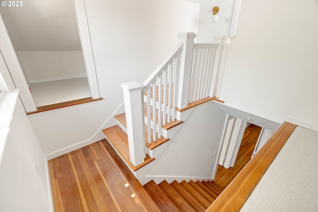stairs featuring wood finished floors