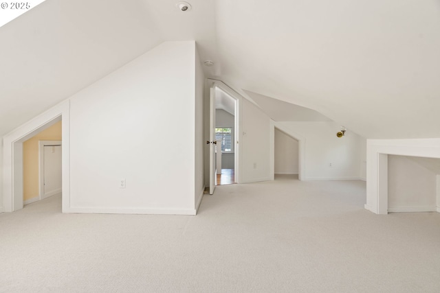 bonus room featuring vaulted ceiling, carpet flooring, and baseboards