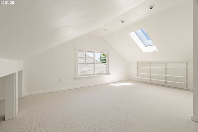 bonus room featuring a skylight, carpet, and lofted ceiling