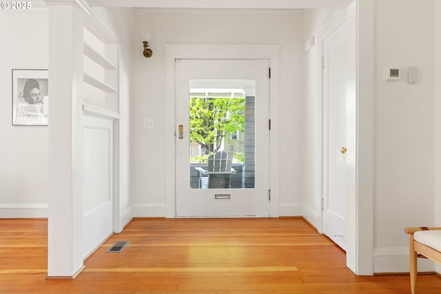 entryway with light wood finished floors and baseboards