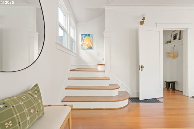 stairway with wood finished floors and baseboards