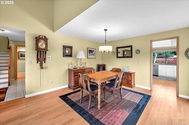 15645 NE Russell Pl, Portland, OR 97230 - dining room with light wood-style flooring, stairway, and a textured ceiling