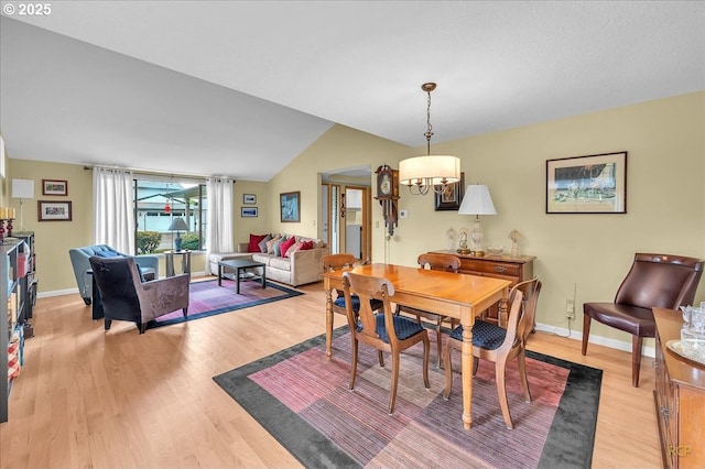 15645 NE Russell Pl, Portland, OR 97230 - dining space featuring light wood-style flooring, a chandelier, and vaulted ceiling