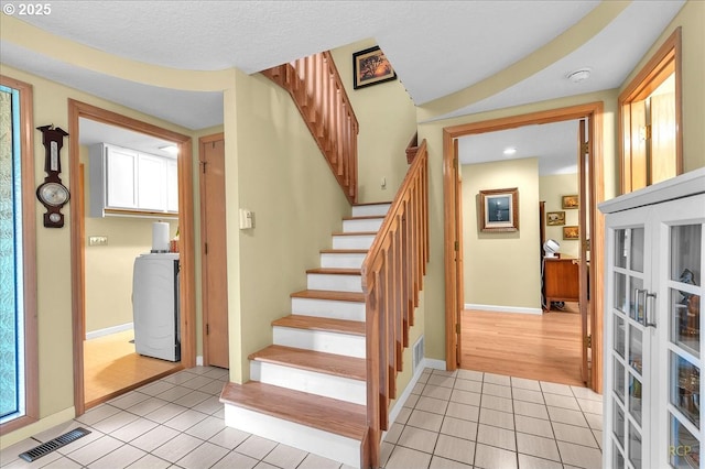 15645 NE Russell Pl, Portland, OR 97230 - stairs with tile patterned flooring, french doors, and recessed lighting