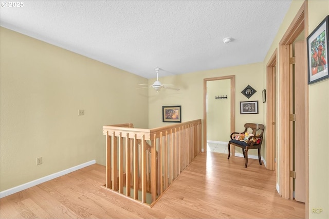 15645 NE Russell Pl, Portland, OR 97230 - corridor with an upstairs landing, light wood-style floors, and a textured ceiling