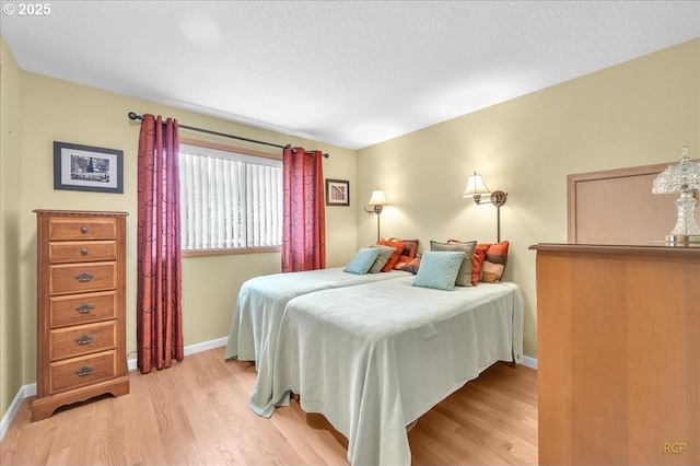 15645 NE Russell Pl, Portland, OR 97230 - bedroom with light wood-style flooring and a textured ceiling