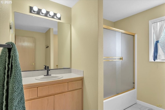 15645 NE Russell Pl, Portland, OR 97230 - bathroom with vanity, bath / shower combo with glass door, and marble look tile flooring